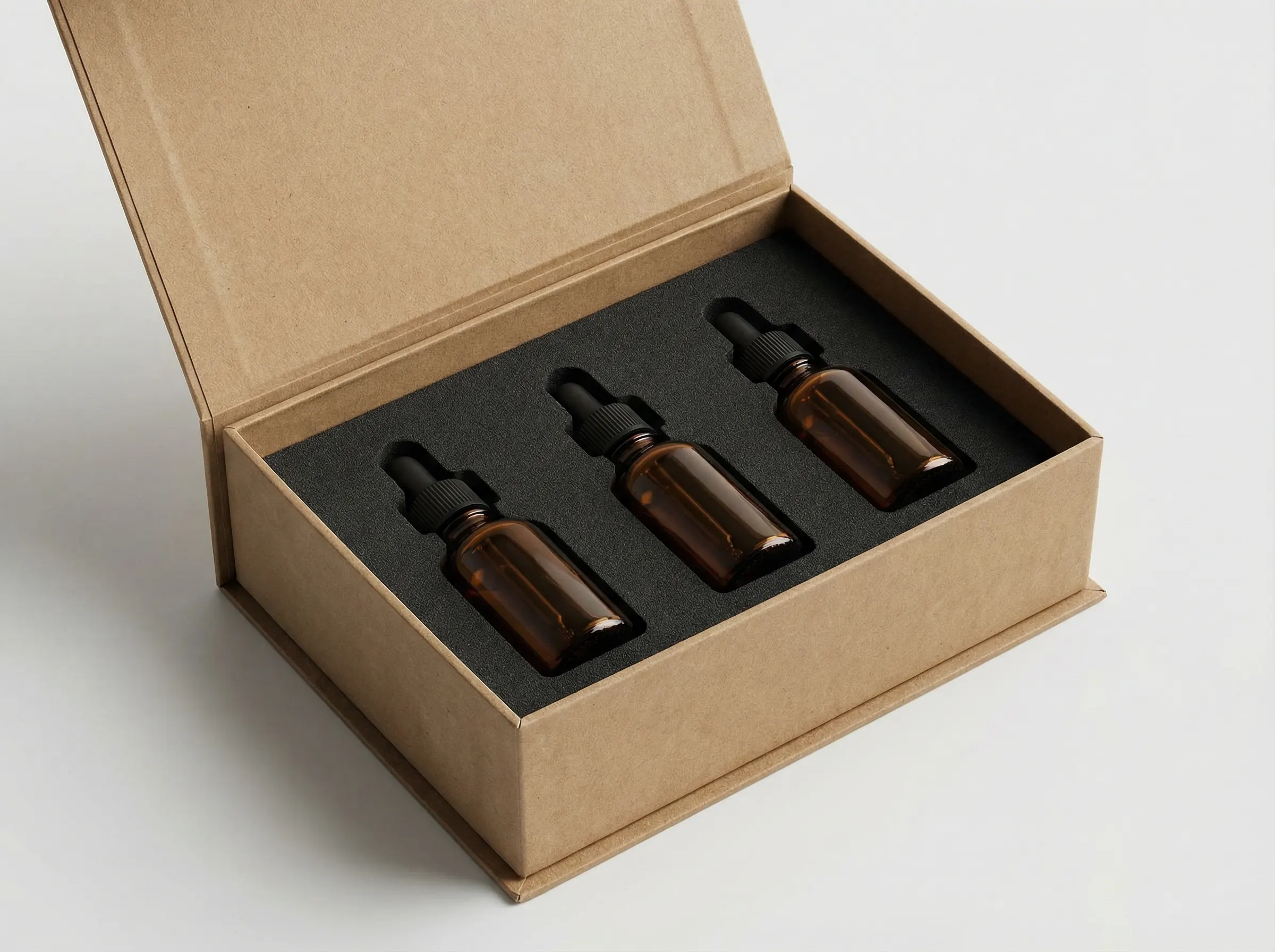 Rigid paper box with thick board and custom EVA foam insert for glass bottle wellness kit packaging.